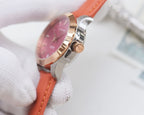 Wristwatch with rose-pink dial and orange leather strap, silver case