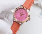 Round wristwatch with pink dial and orange leather strap, silver bezel