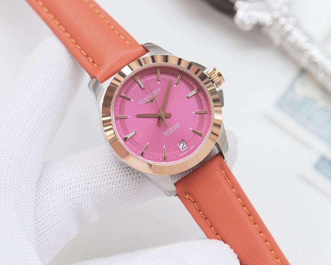 Round wristwatch with pink dial and orange leather strap, silver bezel
