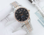 Longines watch with dark dial, gold-accent hands, and stainless steel link bracelet