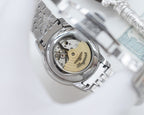 Longines watch case with visible back and coin-edge detailing, on stainless steel bracelet