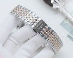 Longines watch bracelet close-up with polished stainless steel links and engraved clasp
