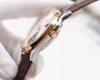 Longines wristwatch side view with rose-gold case and brown leather strap