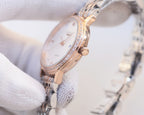 Longines watch with rose-gold case and two-tone bracelet; white dial with crystal bezel