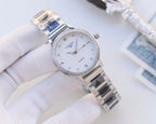 Longines watch with silver bezel and two-tone metal bracelet; white dial, quartz display