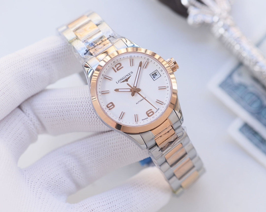 Wristwatch with white dial, rose-gold tone bezel accents, silver link bracelet.