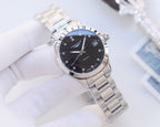 Wristwatch with blue dial, silver link bracelet, circular hour markers.