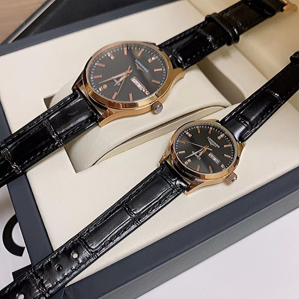 Longines watch with dark dial and black leather strap, gold-tone bezel, in box.
