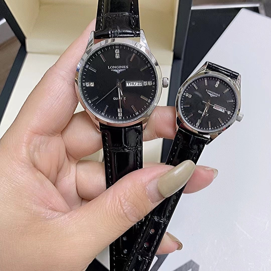 Longines watch close-up: black dial and black leather strap on wrist.