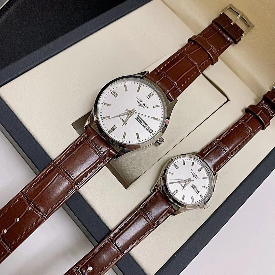 Longines watch set with white dial and brown leather straps, displayed in box.