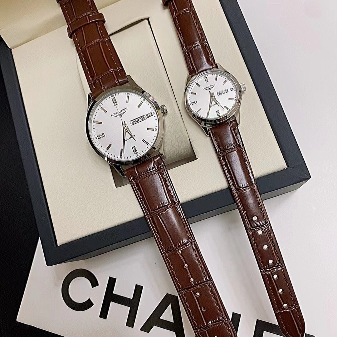 Longines watch pair with white dials and brown leather straps in open box.