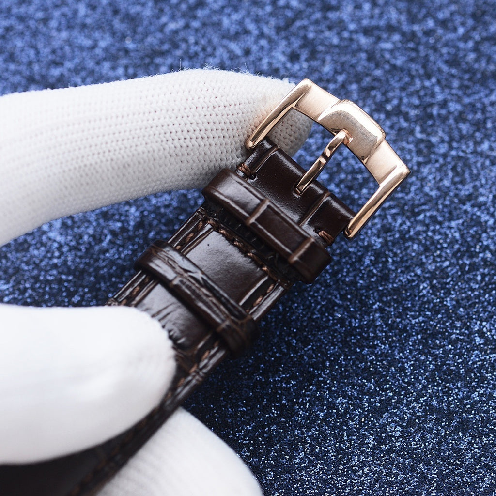 Longines watch strap close-up, brown leather with rectangular gold-tone buckle