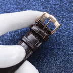 Longines watch strap close-up, brown leather with rectangular gold-tone buckle