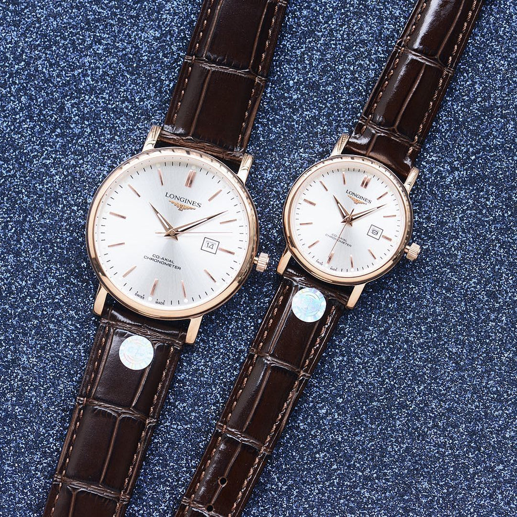 Longines watch pair with white dial and brown leather straps, rose-gold tone cases