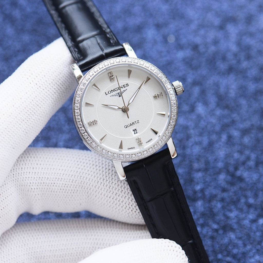 Quartz wristwatch with white dial, crystal bezel, black leather strap.