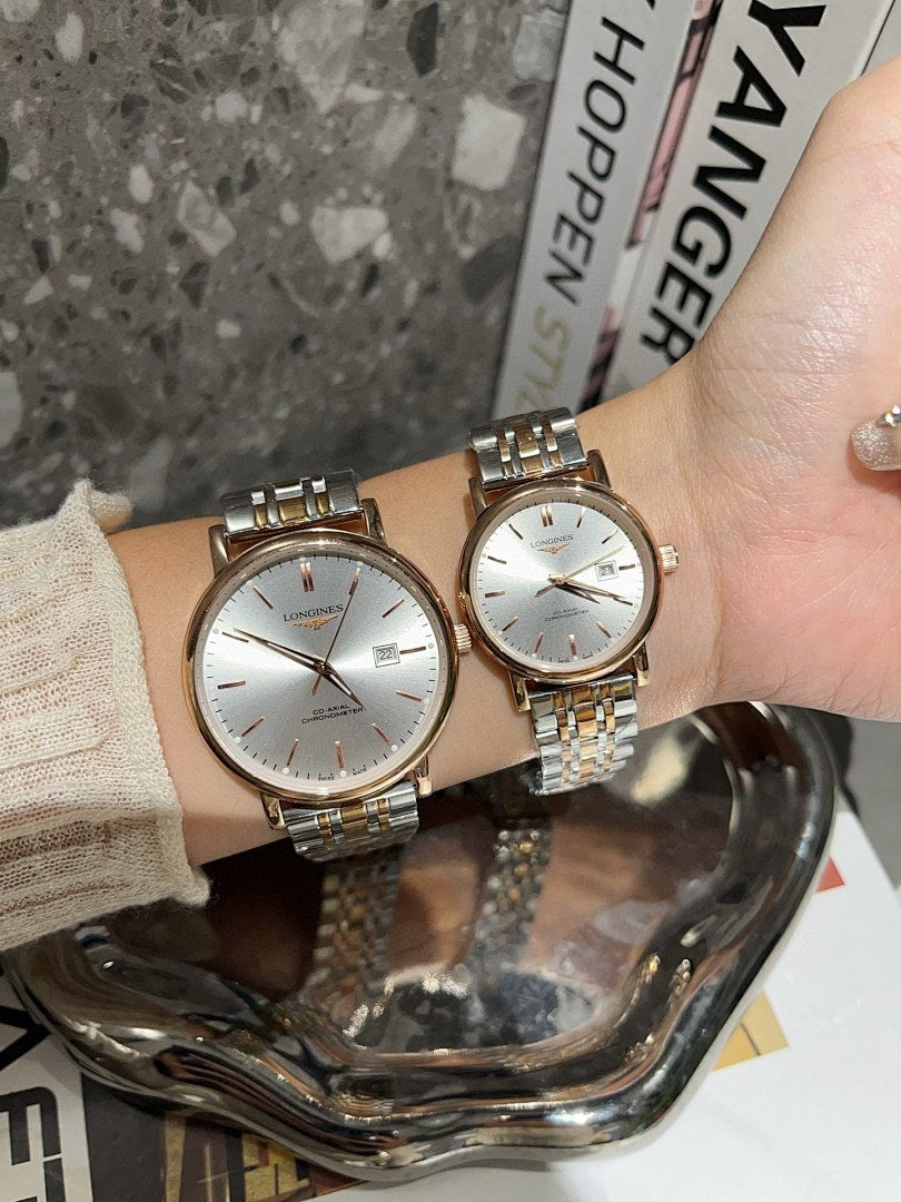 Two Longines watches with white dials and rose-gold and gold-tone link bracelets.