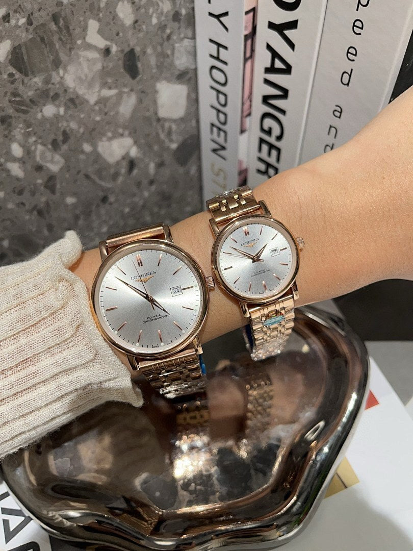 Two Longines watches with white dials and rose-gold and silver-toned metal bracelets.