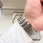 Longines watch bracelet close-up on wrist, silver metal links