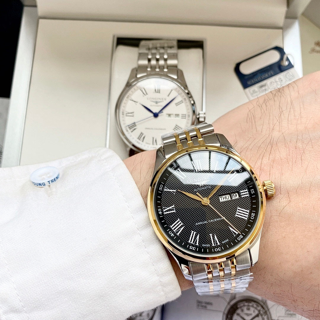 Longines watch with dark dial, gold bezel, and metal bracelet on wrist