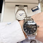 Longines watch with dark dial, gold bezel, and steel-and-gold bracelet on wrist