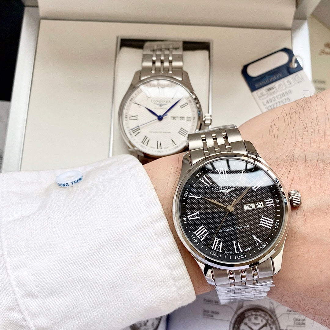 Longines watch with dark dial, gold bezel, and steel-and-gold bracelet on wrist