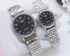 Two stainless steel wristwatches with dark face dials and linked bracelet straps