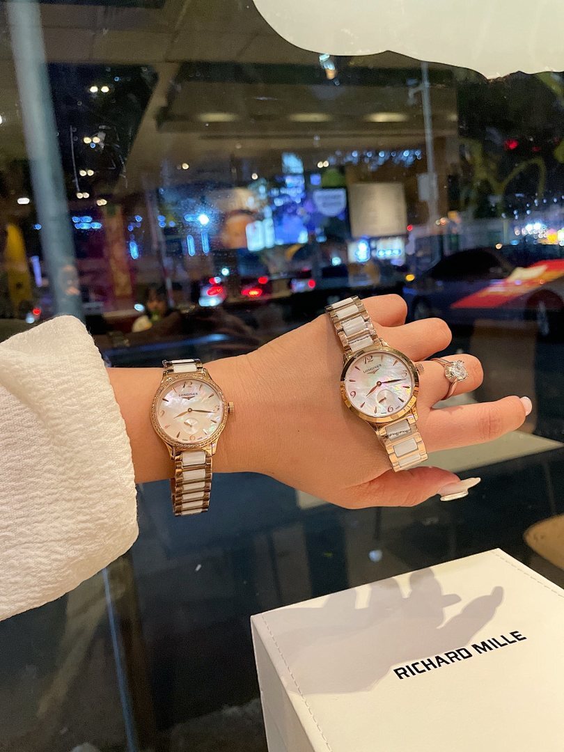 Longines rose gold-tone wristwatch on hand, round dial with subdials and bracelet
