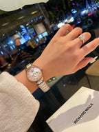 Longines rose gold-tone wristwatch on wrist, round dial with baton markers