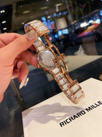 Longines rose gold-tone wristwatch with engraved case back and metal link bracelet