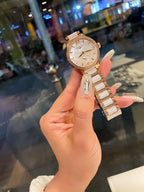 Longines rose gold-tone wristwatch with round dial and metal link bracelet