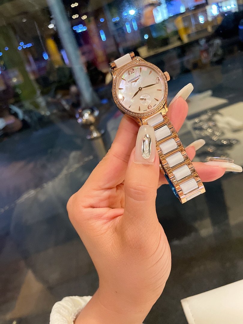 Longines rose gold-tone wristwatch with round dial and metal link bracelet