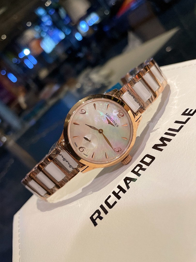 Longines rose gold-tone wristwatch close-up, round dial and bracelet links