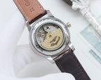 Longines watch with brown leather strap, open caseback showing inner mechanism