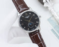 Longines wristwatch with brown leather strap and dark dial, silver case and crown