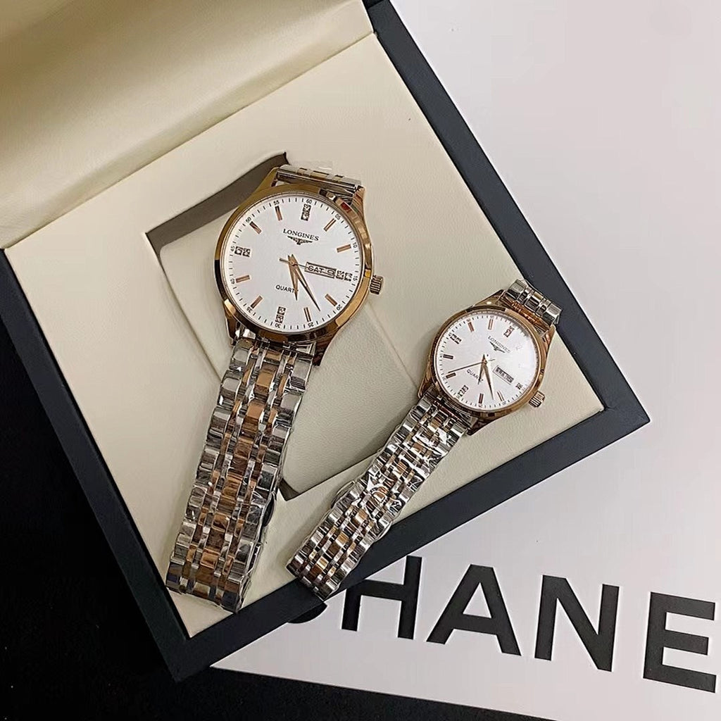 Pair of stainless steel wrist watches with white dials on a padded display tray