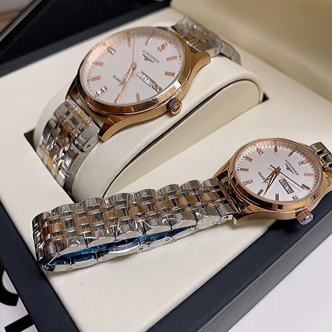 Gold-tone and stainless steel wrist watches with white dials on a box insert