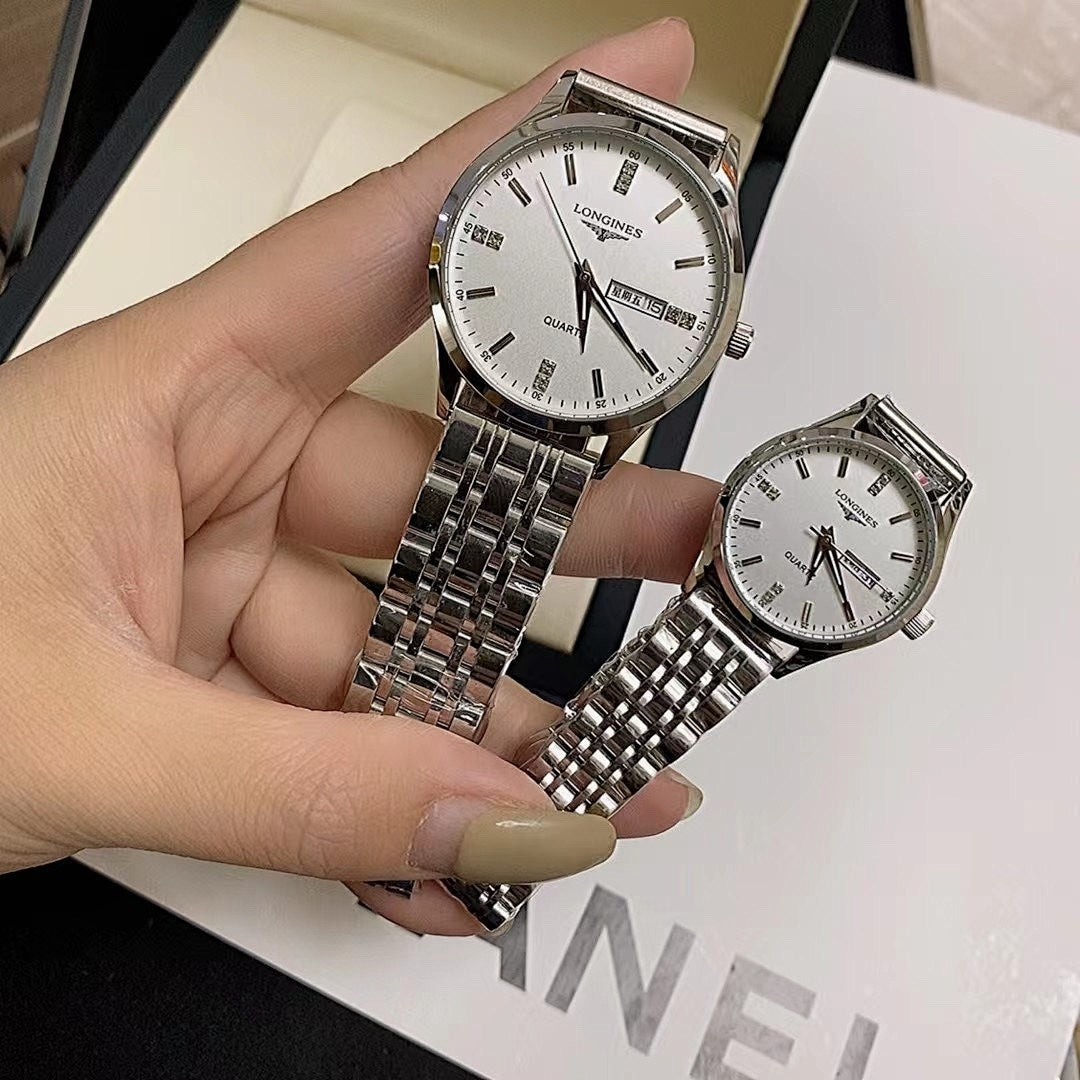 Close-up of two stainless steel wrist watches with white dials and link bracelets