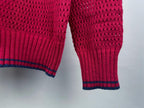 Magenta knit sweater sleeve with ribbed cuff and hem striped in blue