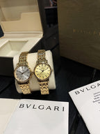 Pair of Omega wristwatches with gold-tone link bracelets and champagne and white dials