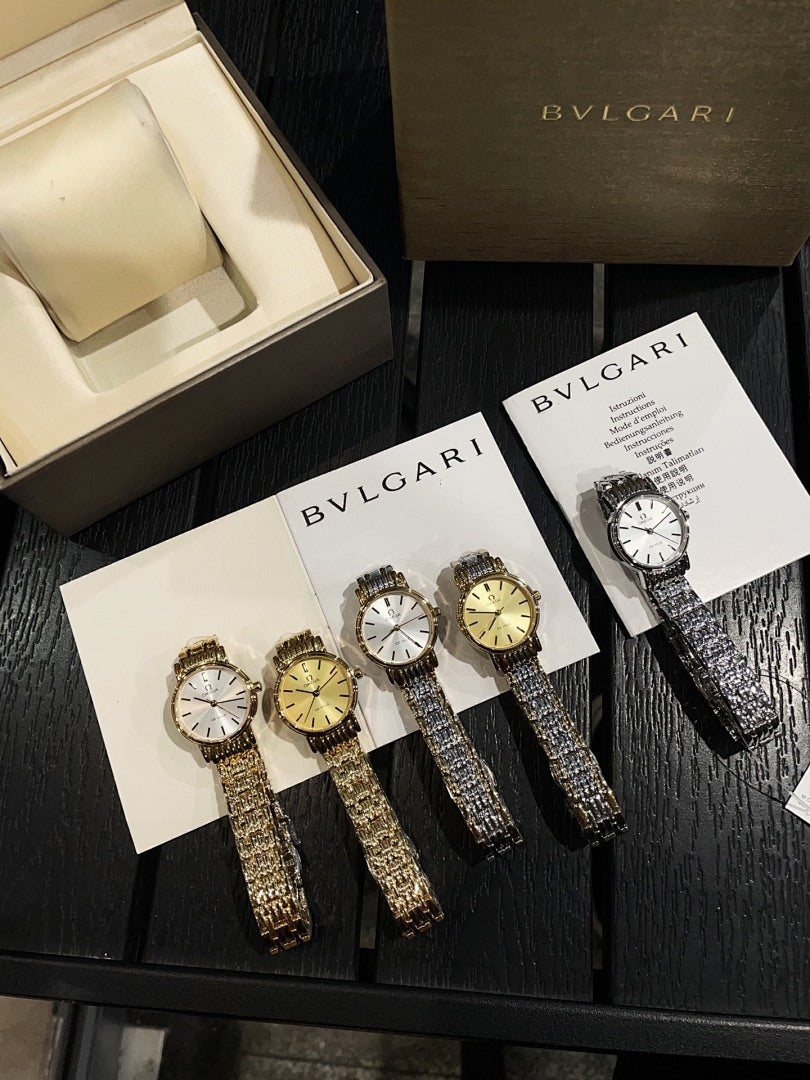 Group of wristwatches with metallic bracelets and round faces on display cards