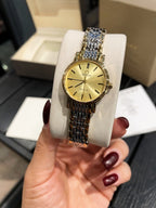 Omega wristwatch with gold-tone case, gold dial, and linked metal bracelet