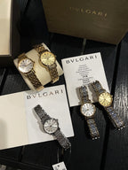 Two Omega wristwatches with metallic bracelets and round dials on display