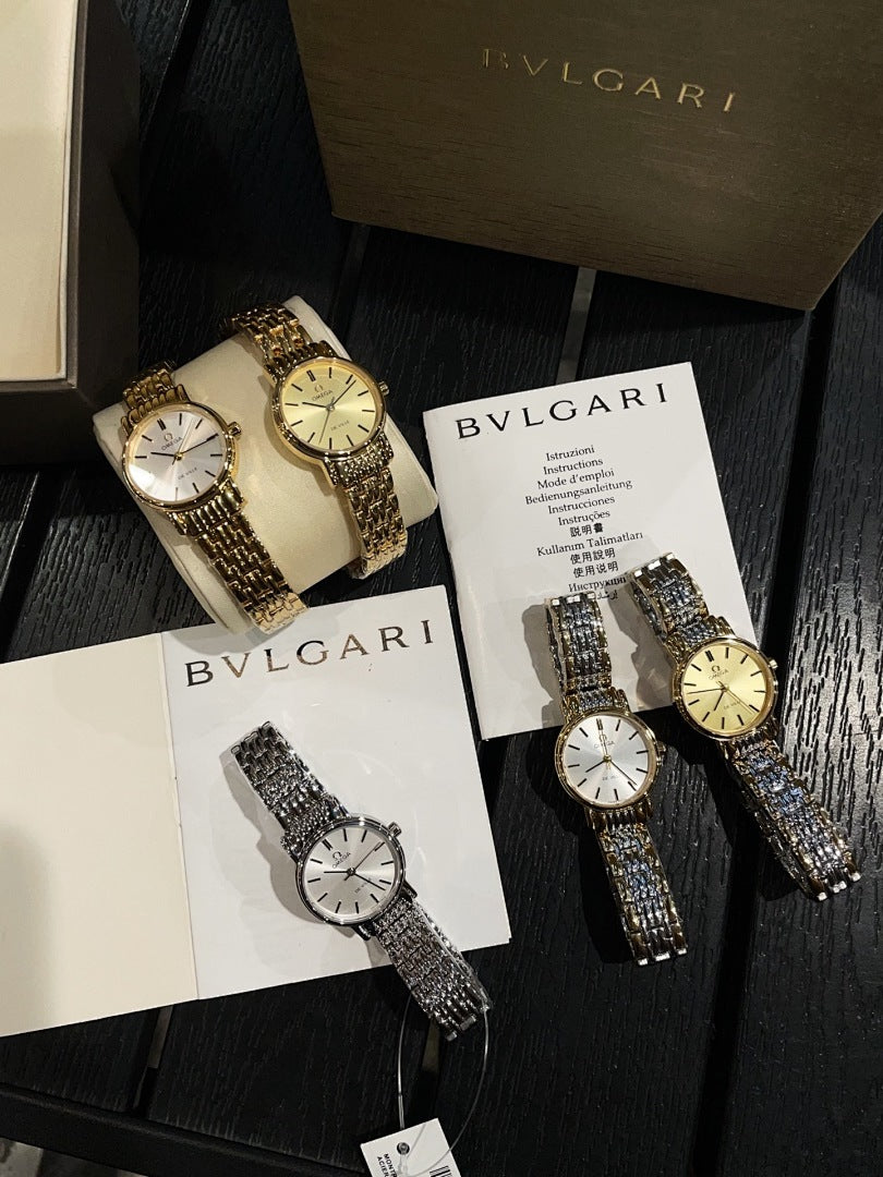 Two Omega wristwatches with metallic bracelets and round dials on display