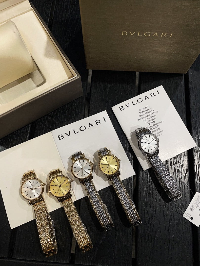 Assorted metallic wristwatches with jeweled bezels displayed on cards