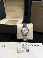 Omega De Ville wristwatch on white display cushion, silver metal bracelet