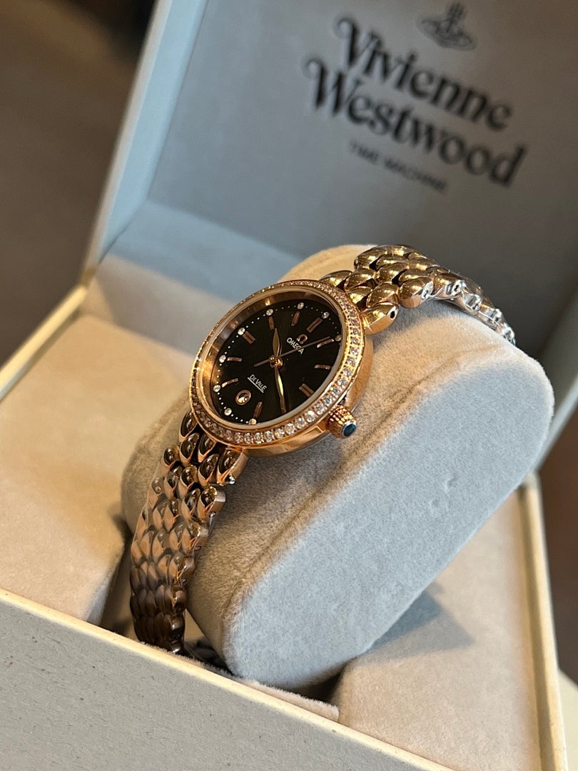 Gold-tone Omega wristwatch with black dial and sparkling gem-set bezel