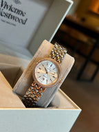 Rose-gold Omega wristwatch with white dial, gem-set bezel, and link bracelet