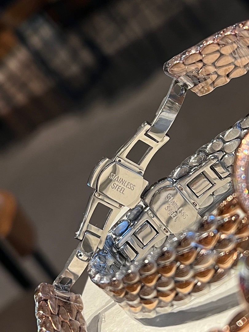 Stainless steel watch bracelet with engraved clasp and patterned link details
