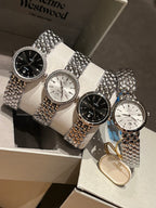 Omega wristwatch set with silver tones, black and white dials, textured bracelets