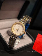 Omega wristwatch with gold-tone case, champagne dial, and textured metal link bracelet